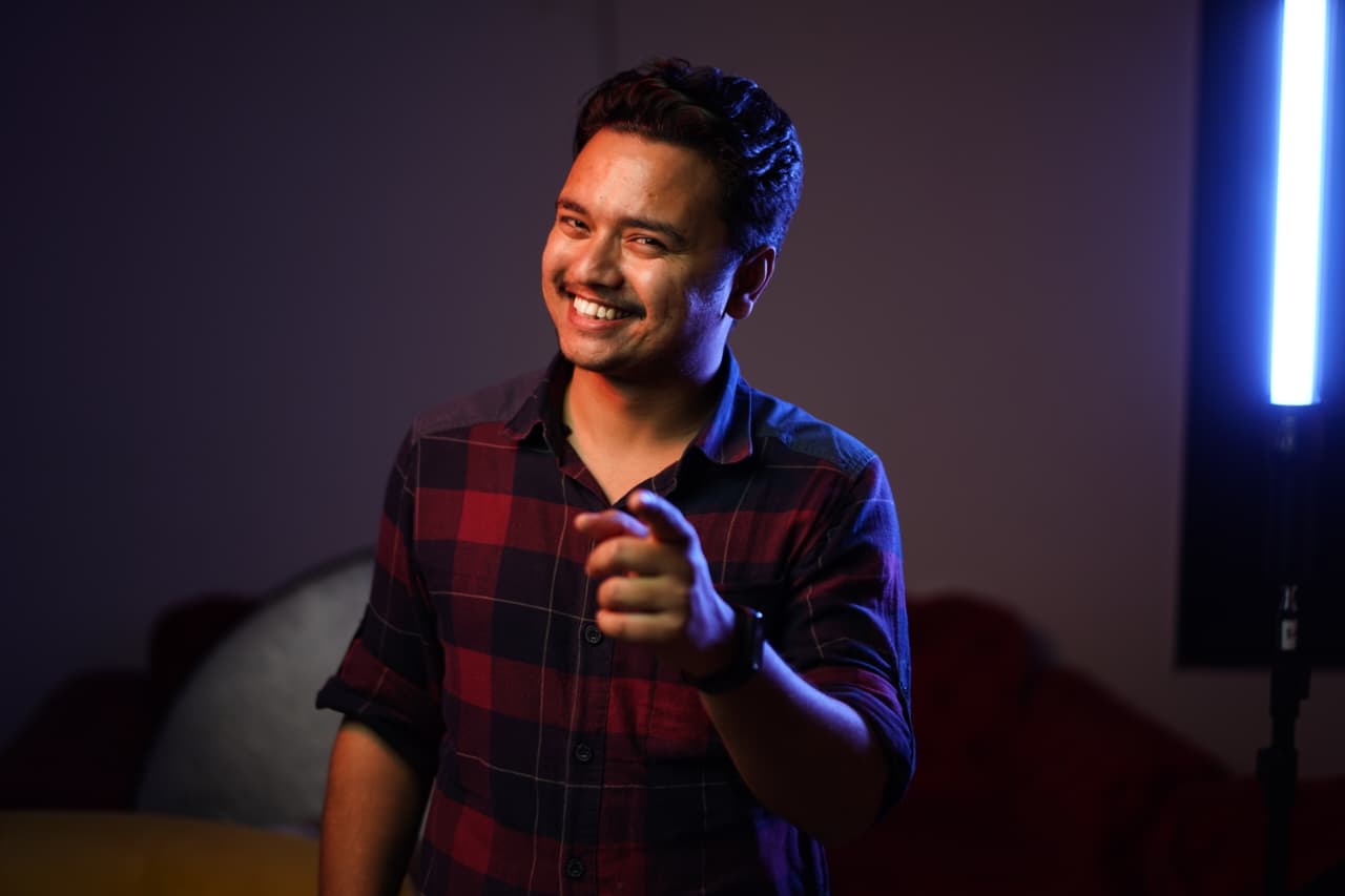 Deepak in neon-lit studio